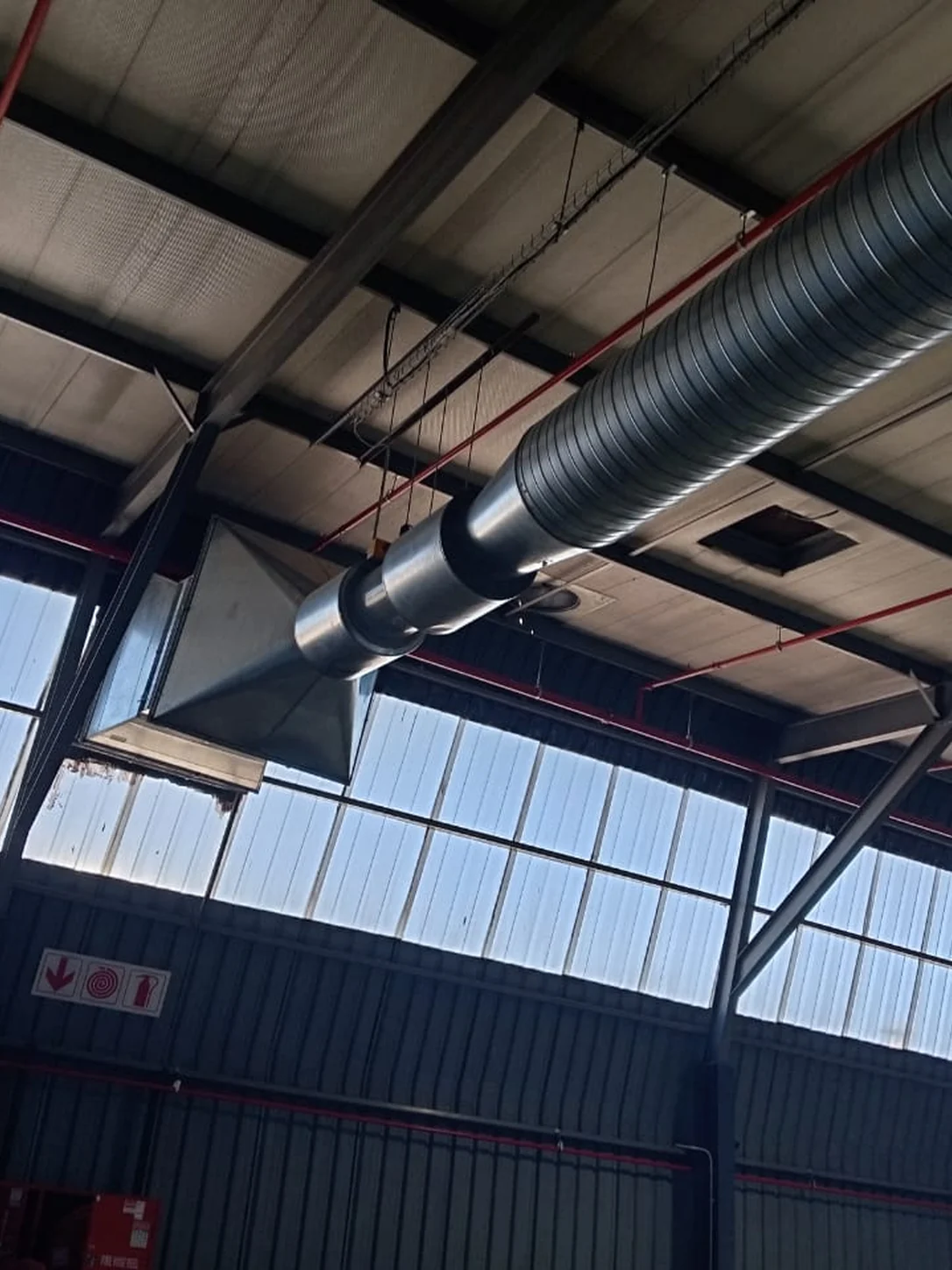 Technicians working with roof ductwork on site